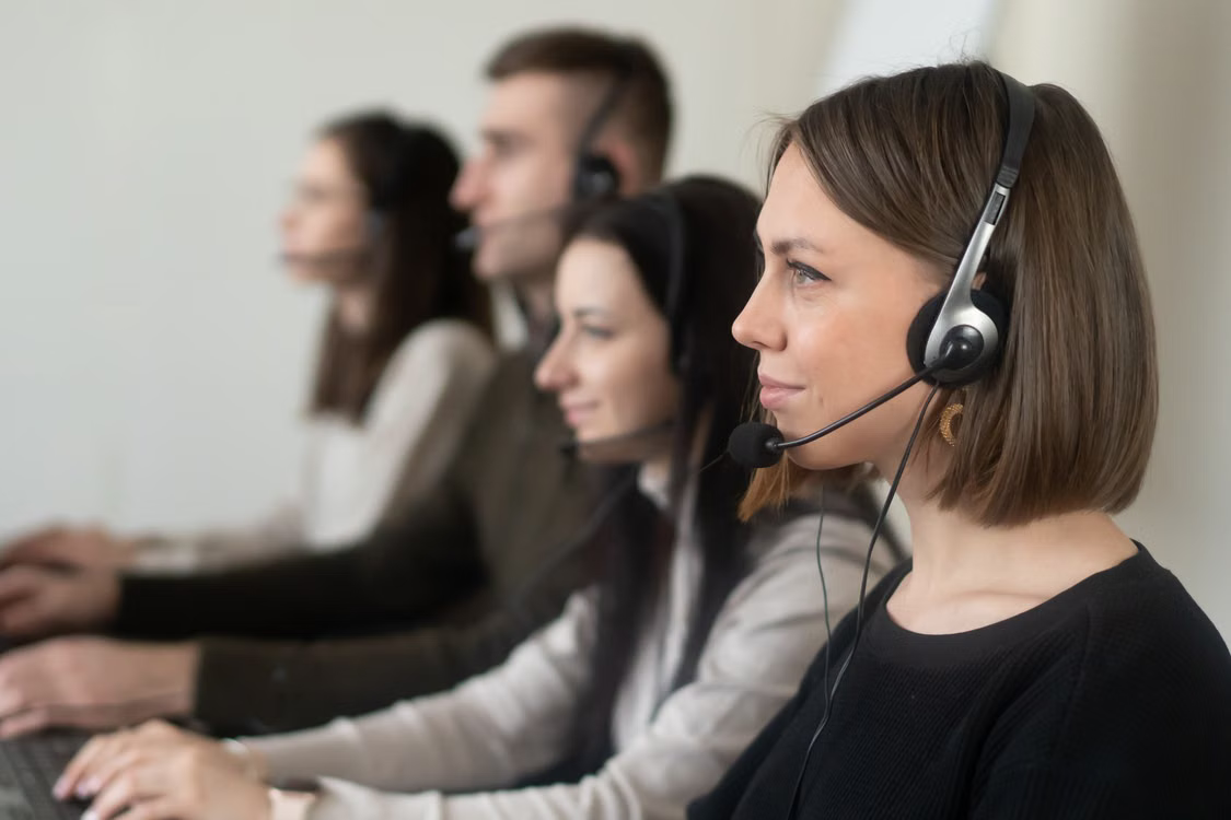 Commercial photography of a customer support team wearing headsets