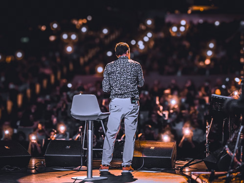 Event photographer view of a speaker onstage facing an audience